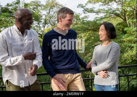 Portrait of diverse group of middle age coworkers having fun and out for a walk Stock Photo