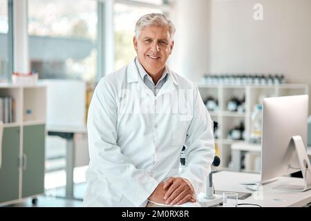 Making advances in his field of study. Portrait of a senior scientist working in a lab. Stock Photo