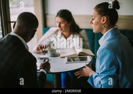 Three students conversating and discussing about their upcoming ...
