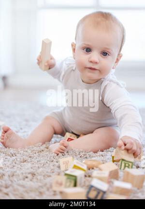 I said back off. an adorable little baby boy playing on the floor at home. Stock Photo