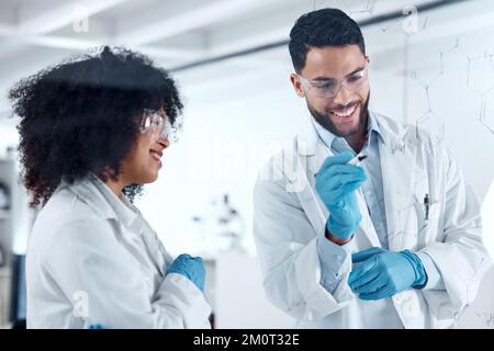 Two young science experts conducting a research experiment in the lab together. Two scientists collaborating, brainstorming during a meeting. Medical Stock Photo
