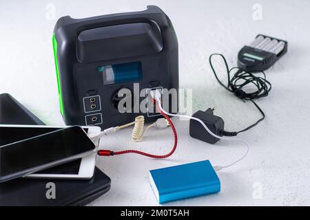 Charging station for phone, tablet, laptop and other gadgets when there is no light during blackout. Generator power bank battery in the absence of electricity. Charge electric rechargeable battery Stock Photo