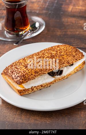 Olive and cheese sandwich with Turkish tea on wooden table Stock Photo
