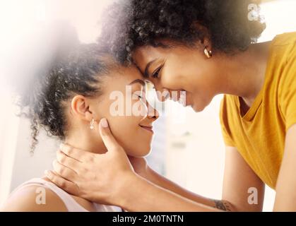 Youre perfect as you are. two young female friends hugging while relaxing at home. Stock Photo