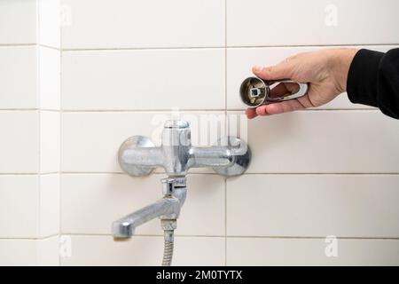 Leaking shower faucet. Broken bathtub handle. Emergency repair Stock Photo