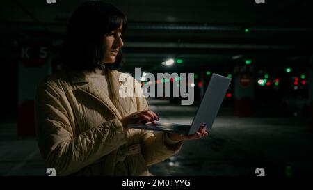 Serious businesswoman specialist woman agent saleswoman technician female inspector girl freelancer with laptop working at parking lot work distant at Stock Photo