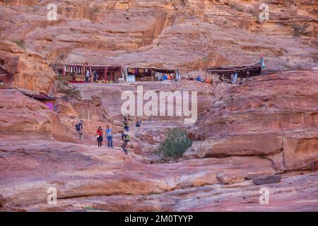 Petra, Jordan - November 3, 2022: People on the road to Monastery, Ad Deir Trail in famous ancient city Stock Photo