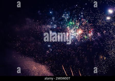 Beautiful multi-colored fireworks against the background of the night sky. High quality photo Stock Photo