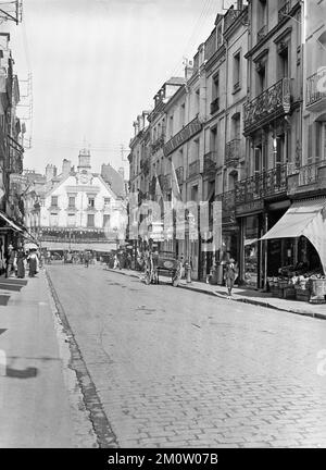 A vintage late 19th Century black and white photograph showing the centre of Dieppe in France. The Cafe Des Tribunaux at the end of the street. Stock Photo