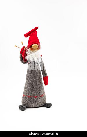 A funny doll with a red cap and a white beard as Santa Claus photographed in the studio against a white background Stock Photo