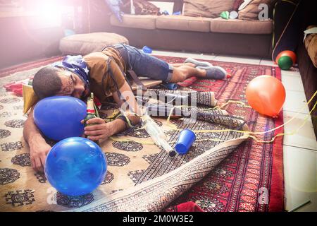 Out like a light. Man sleeping, drunk with alcohol addiction and party, new year celebration with holiday and social event, hungover from drinks Stock Photo