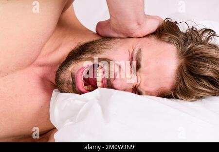 Morning routine tips to feel good all day. How to get up in morning feeling fresh. Late morning overslept. Man handsome guy lay in bed in morning Stock Photo