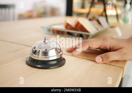 Hand ringing in service bell  Stock Photo