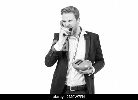 Angry man employee in suit shout in anger to telephone receiver being on vintage phone, bad connection Stock Photo