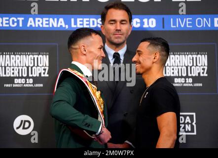 Boxing promoter Eddie Hearn looks on as Josh Warrington (left) and Luis Alberto Lopez face off during a press conference at Aspire, Leeds. Picture date: Thursday December 8, 2022. Stock Photo