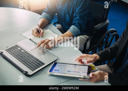 After accident and rehabilitation, disabled man can return to work again. Job hiring employing disable people concept. Stock Photo
