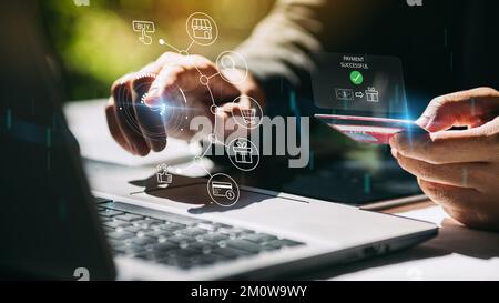 ชื่อ	 Businessman with notebook computer paying online shopping on virtual tech with credit card. Online payment banking transaction and e-commerce. Stock Photo