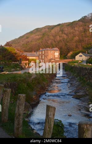 The River Valency Flowing into the Harbour in Boscastle at Sunset on the South West Coastal Path in Cornwall, England, UK. Stock Photo