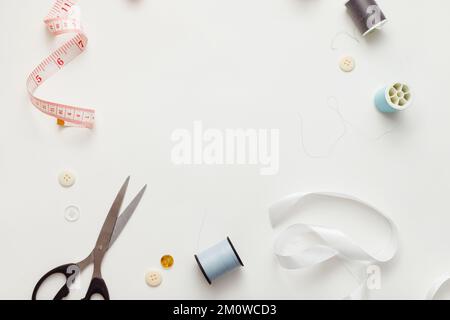 Sewing accessories for repairing clothes, layout on a white background, top view. Stock Photo