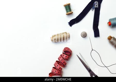 Sewing accessories for repairing clothes, layout on a white background, top view Stock Photo