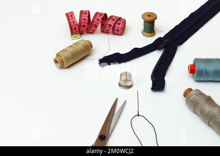 Sewing accessories for repairing clothes, layout on a white background, top view Stock Photo