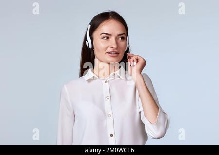woman in headset is consulting clients online. Stock Photo