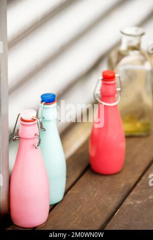 Decorative glass bottles of various colors with airtight stoppers Stock Photo