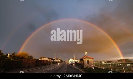 Wadebridge, Cornwall, UK. 8th December 2022. UK Weather. A temperatures started to drop again, showers and sleet swept across North Cornwall bringing this Rainbow over Wadebridge Showground. Credit Simon Maycock / Alamy Live News. Stock Photo