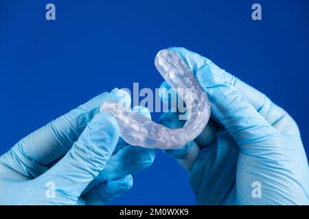 Dental transparent plastic mouthguard, splint for the treatment of dysfunction of the temporomandibular joints, bruxism, malocclusion, to relax the Stock Photo