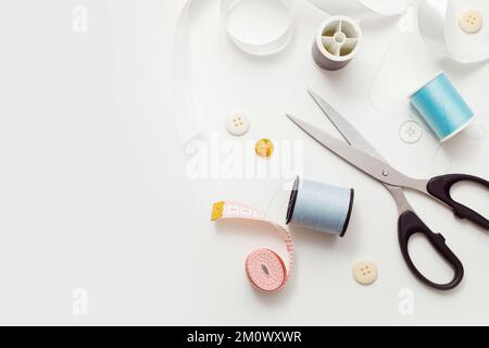 Sewing accessories for repairing clothes, layout on a white background, top view. Stock Photo