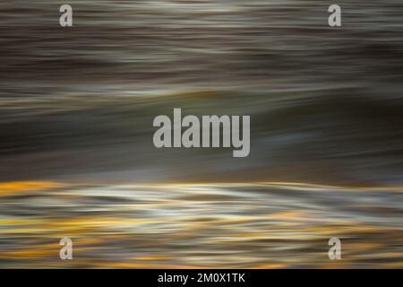 Stormy sea waves at sunset, motion blur. An abstract seascape made with a long exposure. Stock Photo