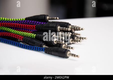Many audio connector jacks laying on white background Stock Photo