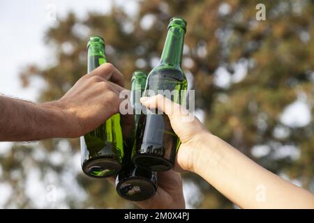 Toasting with beer bottles, Germany, Europe Stock Photo