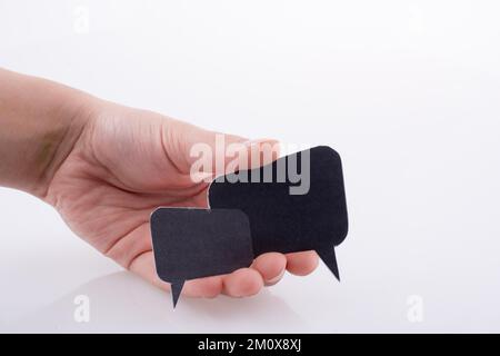 Hand holding dialogue boxes on a white background Stock Photo