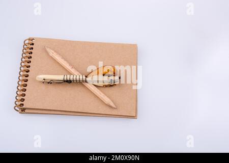 Pencil and Turkish musical instrument saz placed on notebook Stock Photo
