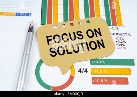 Business concept. On the business charts is a pen and a sign with the inscription - Focus On Solution Stock Photo