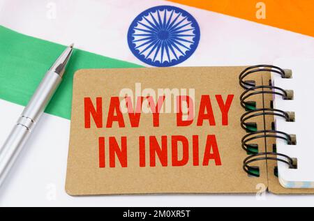 Holidays in India. Against the background of the flag of India lies cardboard with the inscription - Navy Day in India Stock Photo