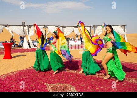 Belly dancers in the Dubai Desert Conservation Reserve. Stock Photo