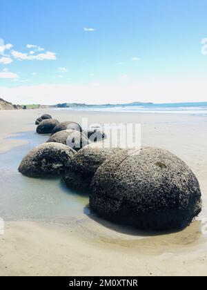 famous large boulders on beach at moeraki, New Zealand. Stock Photo