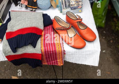 Red vintage shoes, scarf and sweater as interior decoration Stock Photo