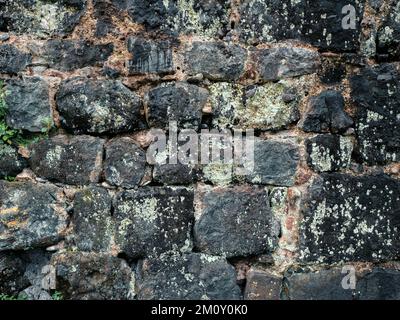 Texture of old black and grey masonry stone wall. Ancient grunge brick-stones background. Stock Photo