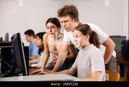 Portrait of female and male students working on computers in class Stock Photo