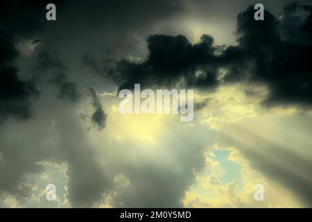 Autumn sky with sun rays through light and soft clouds. Crepuscular rays Stock Photo