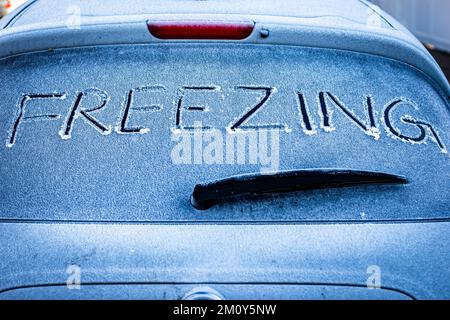Car parked overnight with FREEZING sign written on rear window.A concept of COLD ,commercial image for car products and breakdown services ! Stock Photo