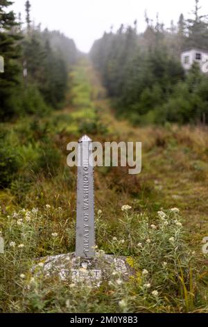 Stone border marker along international boundary USA Canada Stock Photo