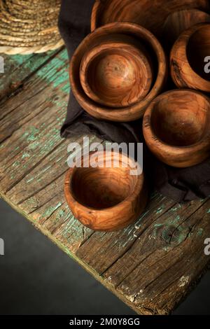 Olive wood bowls on a green table. Stock Photo