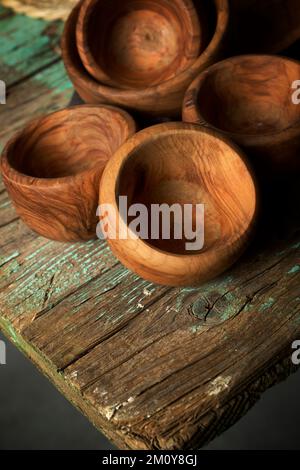 Olive wood bowls on a green table. Stock Photo