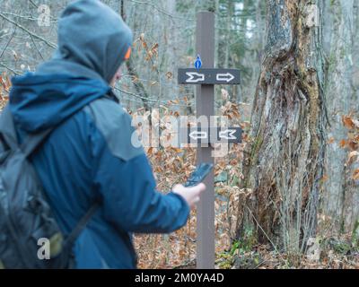 Cross roads on hiking trail, sign decision which way Stock Photo