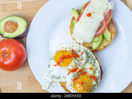 Top down toasted bagel sandwich with egg and vegetables Stock Photo