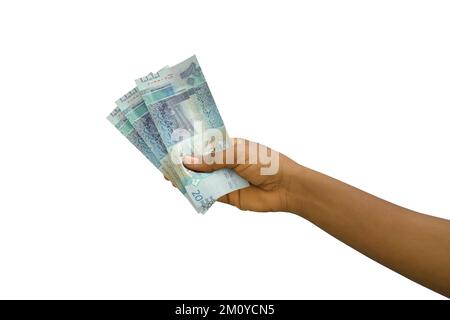 Fair hand holding 3D rendered Kuwaiti dinar notes isolated on white background Stock Photo